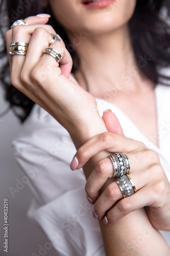 Female hands with jewelry near the face