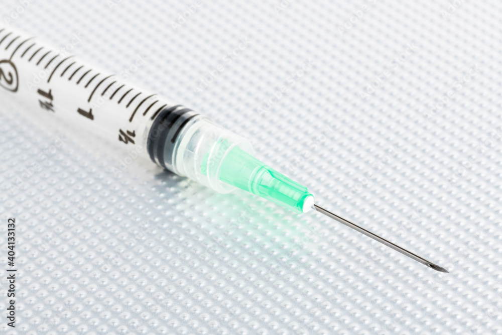 Hygienic Single-Use Disposable Injection On Metal Background Hygienic Single-Use Disposable Injection On Metal Background