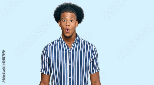 African american man with afro hair wearing casual clothes scared and amazed with open mouth for surprise, disbelief face