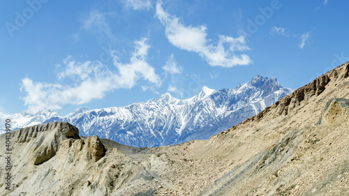 Barren landscape and snow-capped mountains on the trail from Muktinath to Kagbeni, Annapurna Circuit, Nepal