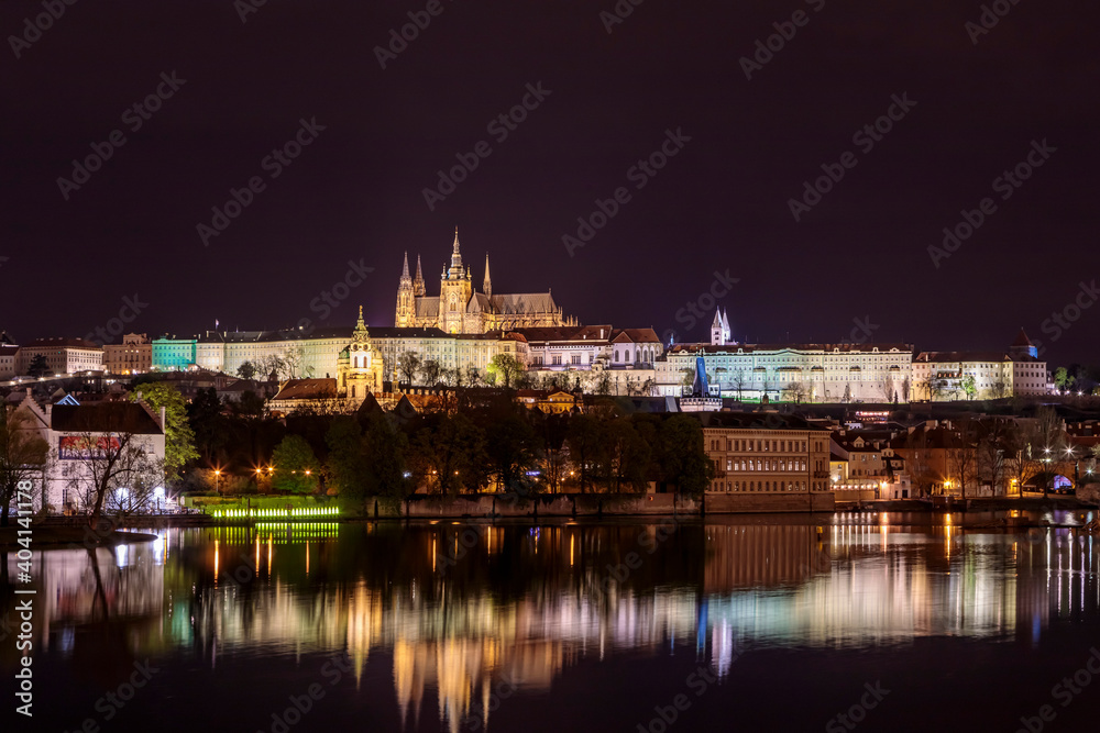 Prague in the evening with colorful lights and reflection in the river