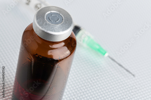 Disposable Injection And Amber Color Vial On Metal Background