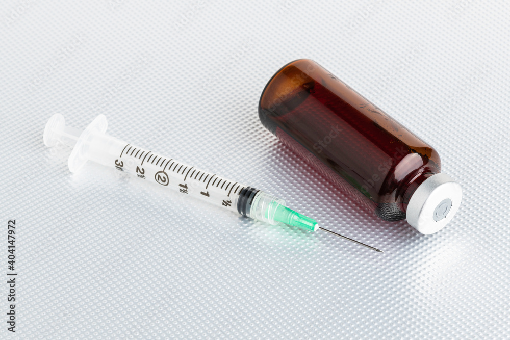 Disposable Injection And Amber Color Vial On Metal Background Disposable Injection And Amber Color Vial On Metal Background
