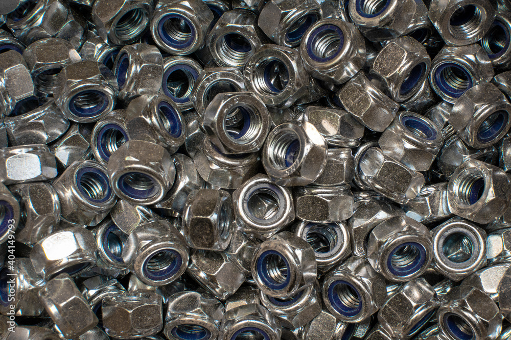 Shining wheel mounting nuts close-up. Industrial background. Shining wheel mounting nuts close-up. Industrial background.