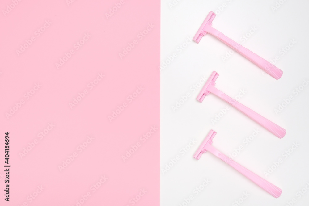 Pink disposable plastic woman razor blade for shaving, body care and unwatred hair removing on legs, armpits and face, flat lay with copy space Pink disposable plastic woman razor blade for shaving, body care and unwatred hair removing on legs, armpits and face, flat lay with copy space