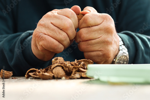 Man cleaning walnuts  Hands closeup.