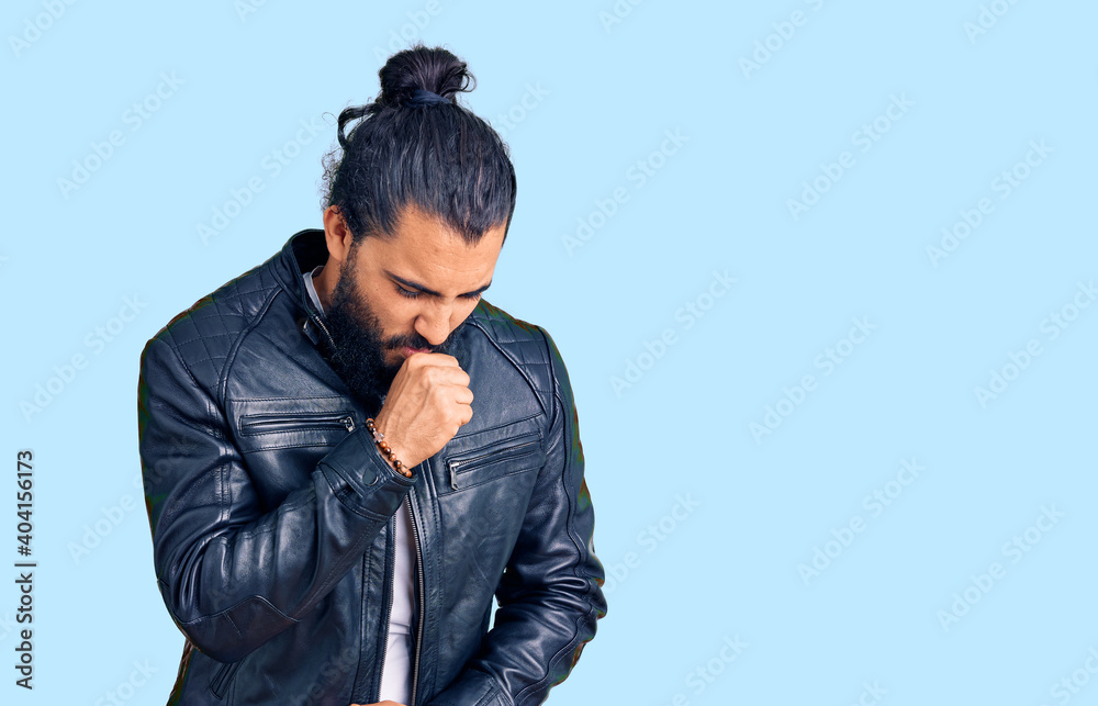 Young arab man wearing casual leather jacket feeling unwell and coughing as symptom for cold or bronchitis. health care concept. Young arab man wearing casual leather jacket feeling unwell and coughing as symptom for cold or bronchitis. health care concept.