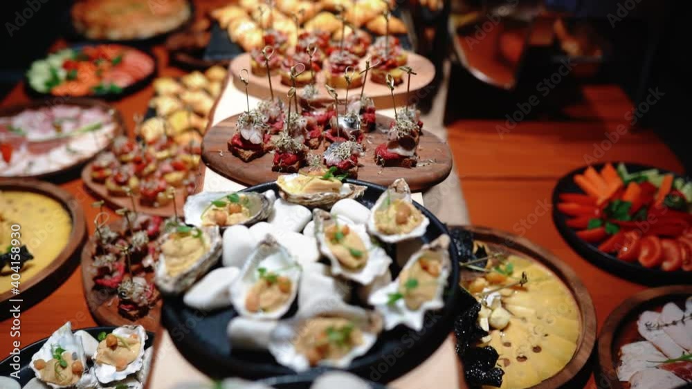 Buffet heated trays with sausages, in hotel luxury restaurant. All inclusive. Buffet food. Hotel serves buffet for breakfast. People with plates choose their dishes. Dining at the hotel of Egypt