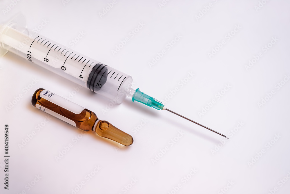 Syringe, needle and a medication vial on a white background Syringe, needle and a medication vial on a white background
