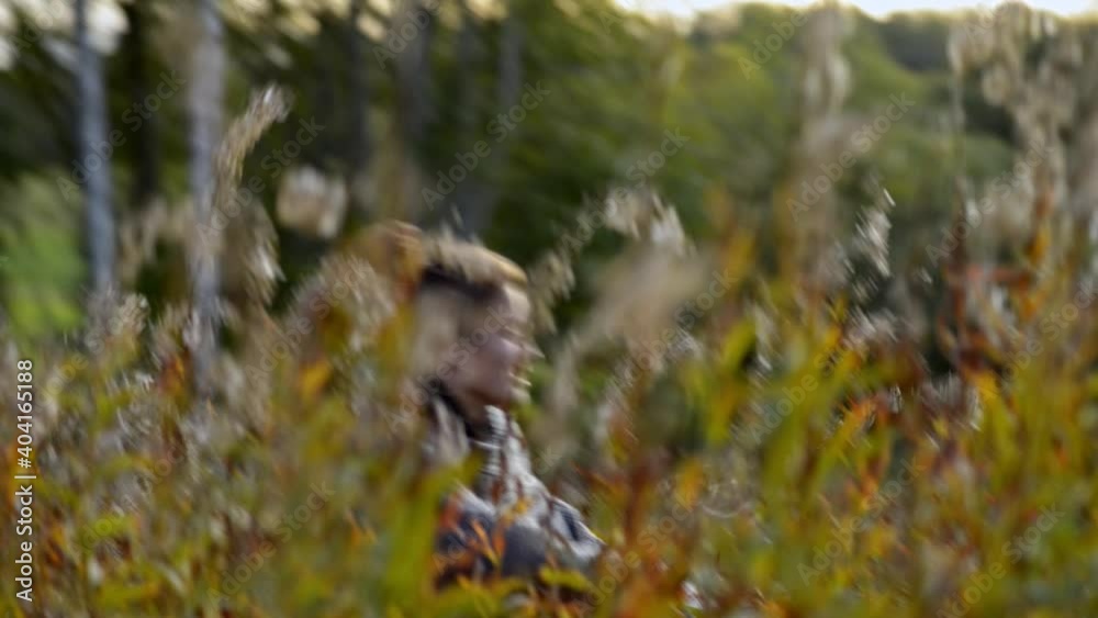 Scared female running fast through the golden meadow Scared female running fast through the golden meadow