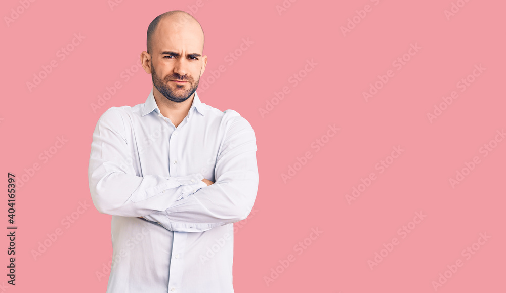 Young handsome man wearing elegant shirt skeptic and nervous, disapproving expression on face with crossed arms. negative person. Young handsome man wearing elegant shirt skeptic and nervous, disapproving expression on face with crossed arms. negative person.