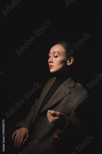 girl in a formal suit and in the dark