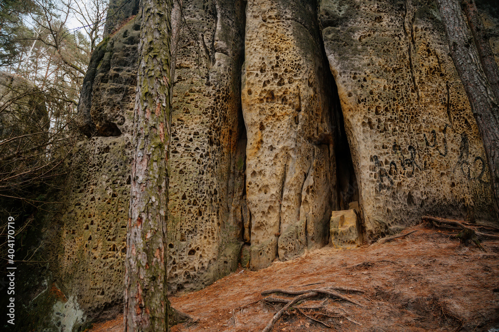 Hiking trail with tourist mark on stone, sandstone rock formation, Rock city Maze in Kokorinsko, Cinibulkova stezka near Mseno, Mysterious gorge in autumn forest, Czech Republic