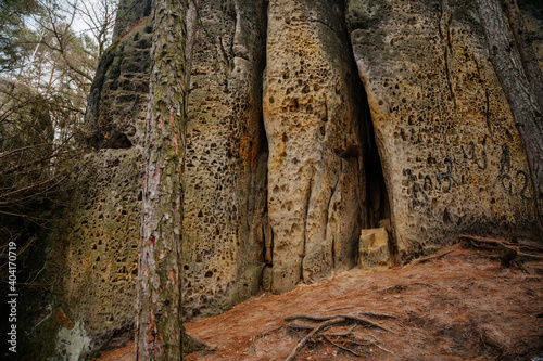 Hiking trail with tourist mark on stone, sandstone rock formation, Rock city Maze in Kokorinsko, Cinibulkova stezka near Mseno, Mysterious gorge in autumn forest, Czech Republic photo