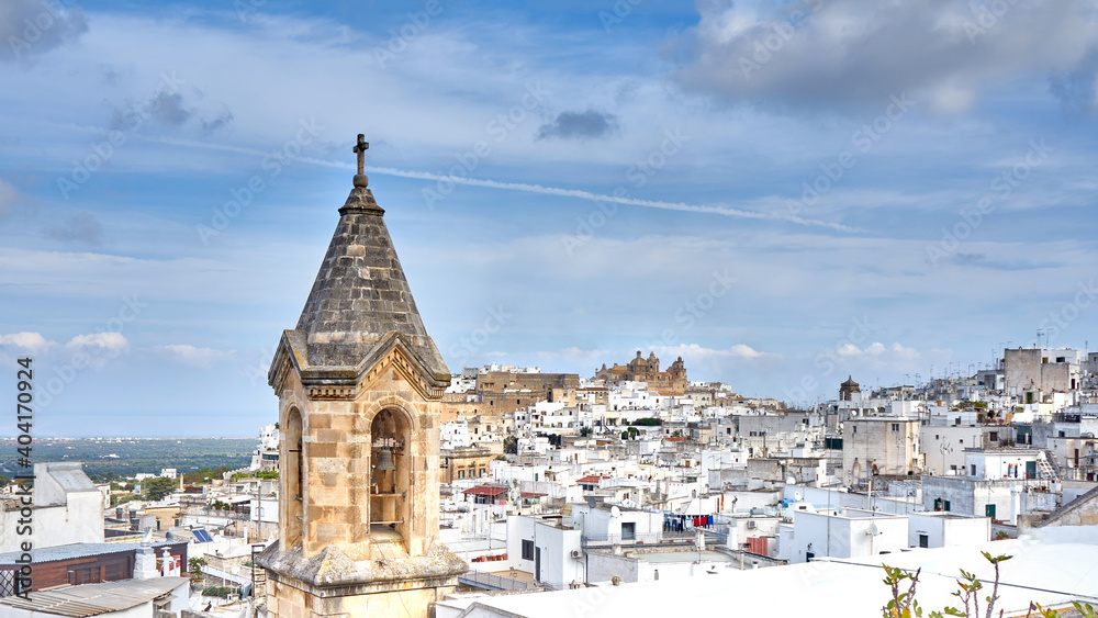 View of the old white town of Ostuni and the cathedral at sunrise. Brindisi, Apulia in southern Italy. Europe.