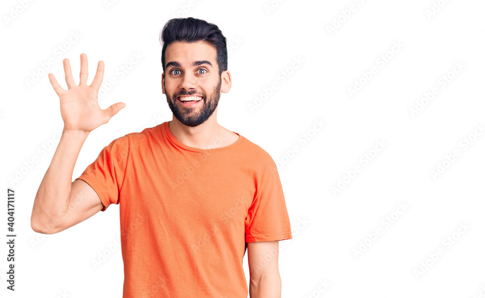 Young handsome man with beard wearing casual t-shirt showing and pointing up with fingers number five while smiling confident and happy. Young handsome man with beard wearing casual t-shirt showing and pointing up with fingers number five while smiling confident and happy.