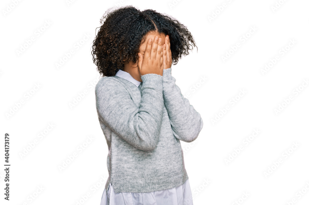 Young little girl with afro hair wearing casual clothes with sad expression covering face with hands while crying. depression concept.