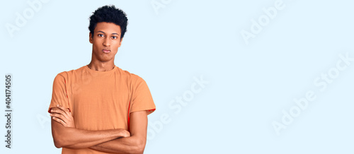 Young african american man wearing casual clothes skeptic and nervous, disapproving expression on face with crossed arms. negative person.