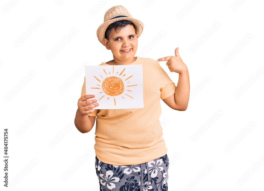 Little boy kid holding sun draw pointing finger to one self smiling happy and proud Little boy kid holding sun draw pointing finger to one self smiling happy and proud