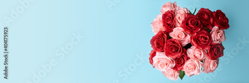 artificial red and pink roses in blue background to celebrate anniversary  happy valentine  s day or mother day wallpaper  flyers  invitation  posters  brochure  banners 