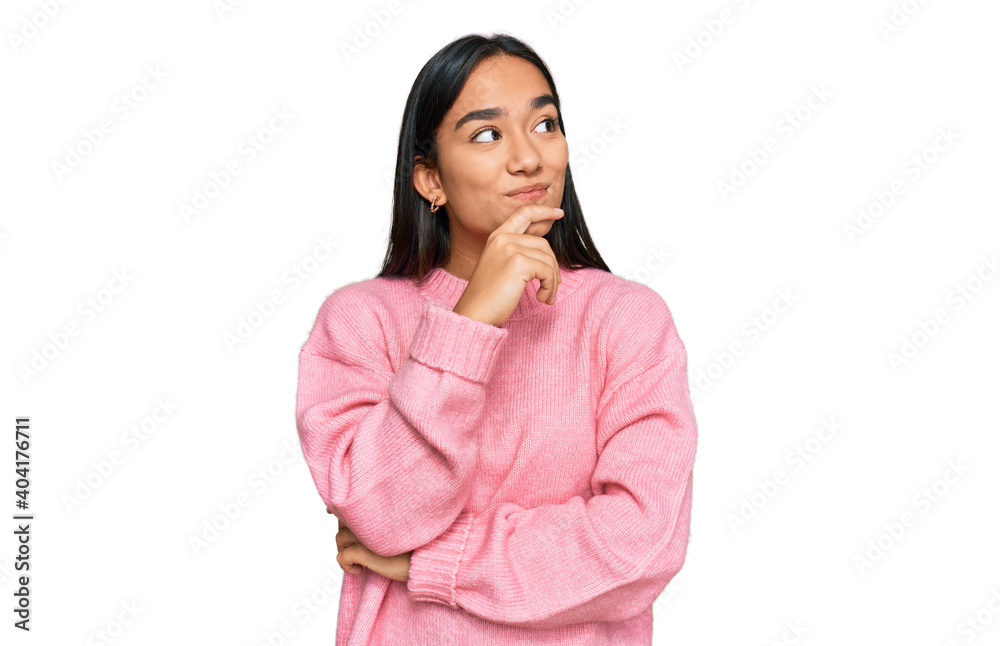 Young asian woman wearing casual winter sweater with hand on chin thinking about question, pensive expression. smiling with thoughtful face. doubt concept. Young asian woman wearing casual winter sweater with hand on chin thinking about question, pensive expression. smiling with thoughtful face. doubt concept.