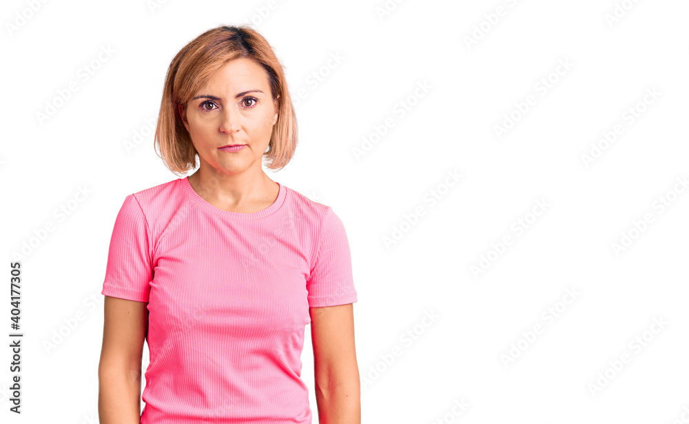 Young blonde woman wearing sportswear relaxed with serious expression on face. simple and natural looking at the camera. Young blonde woman wearing sportswear relaxed with serious expression on face. simple and natural looking at the camera.