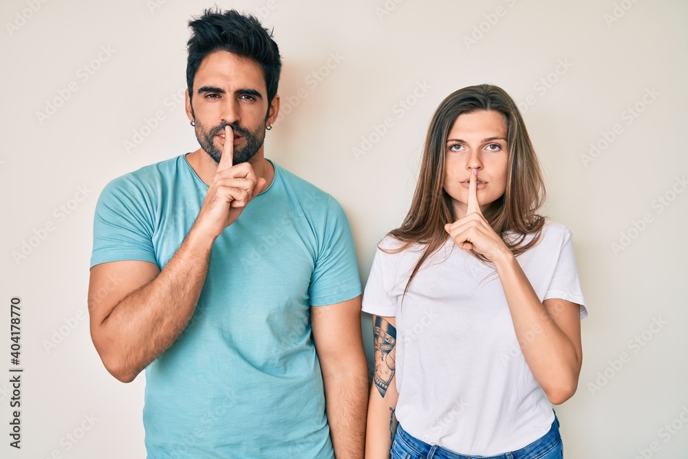 custom made wallpaper toronto digitalBeautiful young couple of boyfriend and girlfriend together asking to be quiet with finger on lips. silence and secret concept.