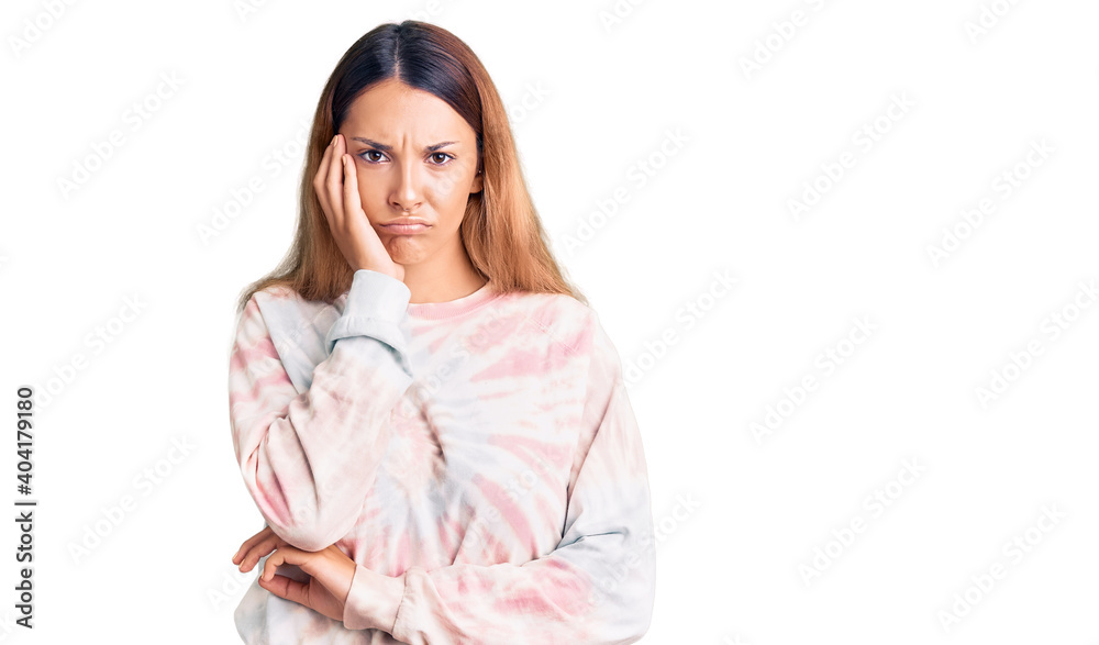 Beautiful young woman wearing casual tie dye sweatshirt thinking looking tired and bored with depression problems with crossed arms. Beautiful young woman wearing casual tie dye sweatshirt thinking looking tired and bored with depression problems with crossed arms.