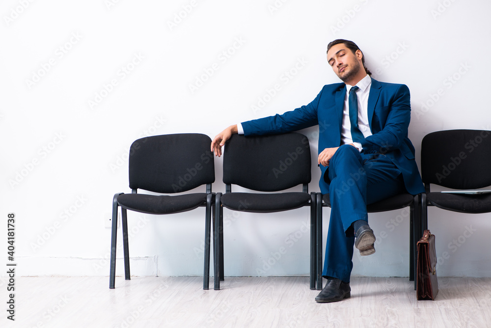 Young businessman waiting for an interview at hall Young businessman waiting for an interview at hall