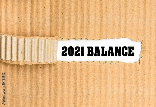 Balance text, on the white background on the torn corrugated business paper.