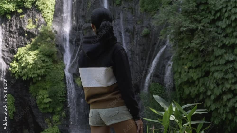 athletic girl in short shorts enjoys the view of the Sekumpul falls,Bali athletic girl in short shorts enjoys the view of the Sekumpul falls,Bali