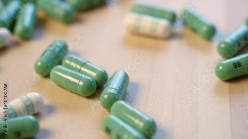 Zooming approach of a spilt bottle of pills on a tabletop