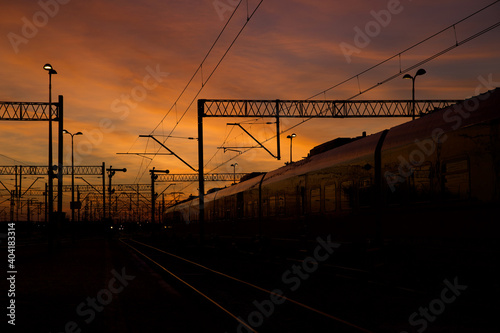 Colorful sky at sunset with visible elements of the railway infrastructure.