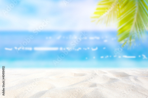 Summer background. Sea and sand, sunlight The tropical beach is blurry with abstract bokeh. Copy space for holiday makers and concepts.