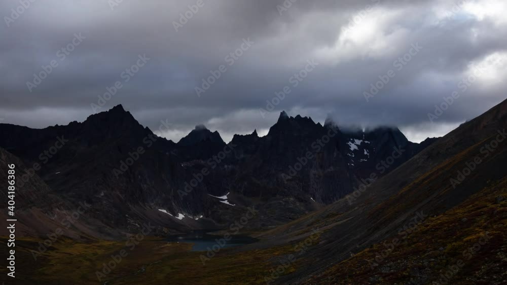 Grizzly Lake in Tombstone Territorial Park, Yukon, Canada. Cloudy morning Timelapse. Snow with Autumn Colors. Canadian Rocky Mountain Landscape. Colorful and Vibrant. Aerial View Grizzly Lake in Tombstone Territorial Park, Yukon, Canada. Cloudy morning Timelapse. Snow with Autumn Colors. Canadian Rocky Mountain Landscape. Colorful and Vibrant. Aerial View