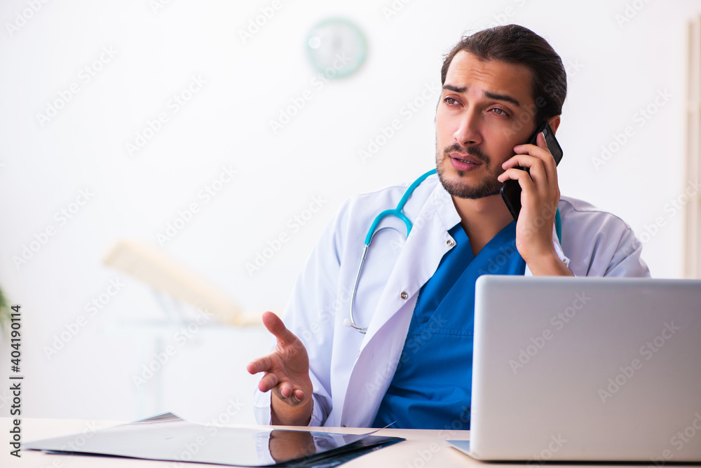 Young male doctor in telemedicine concept Young male doctor in telemedicine concept