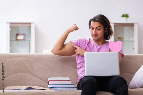 Male student in love preparing for exams at home