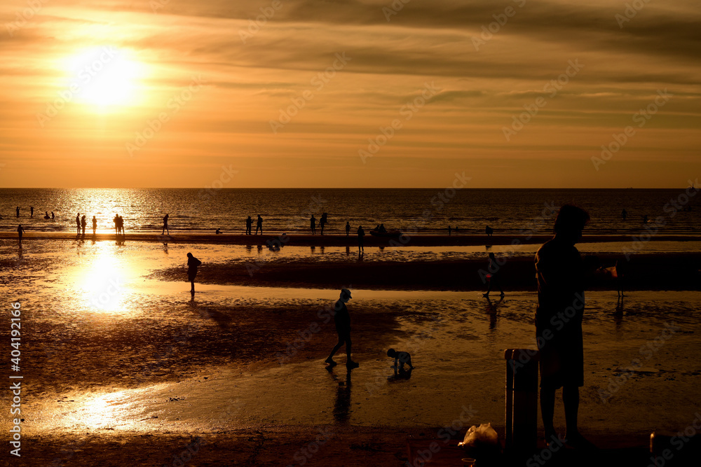 Beautiful golden yellow sky and sun The view of the beach, the beach and the sun loungers are rising. Beautiful golden yellow sky and sun Beautiful golden yellow sky and sun The view of the beach, the beach and the sun loungers are rising. Beautiful golden yellow sky and sun