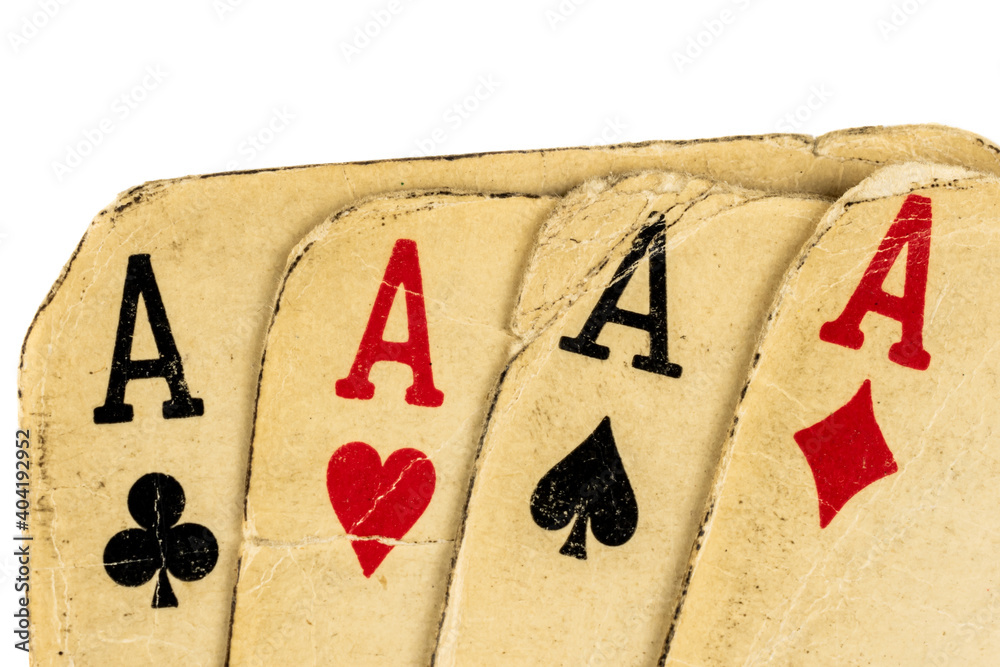 Four old dirty aces poker cards on a white background