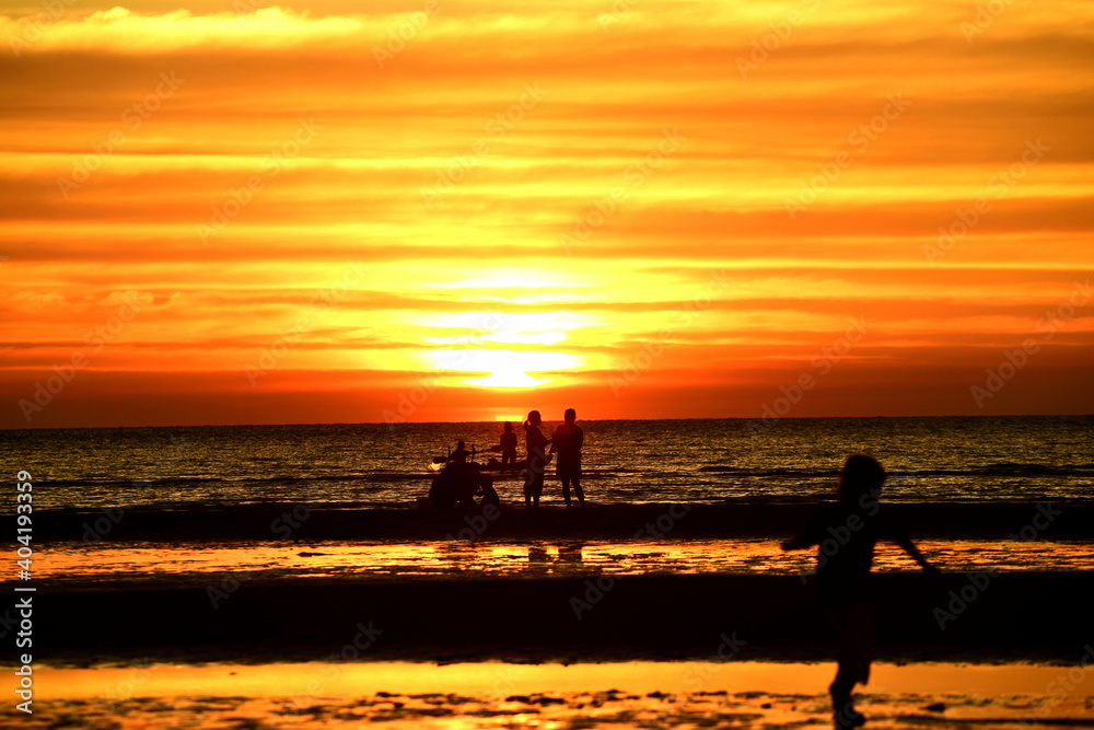Beautiful golden yellow sky and sun The view of the beach, the beach and the sun loungers are rising. Beautiful golden yellow sky and sun Beautiful golden yellow sky and sun The view of the beach, the beach and the sun loungers are rising. Beautiful golden yellow sky and sun