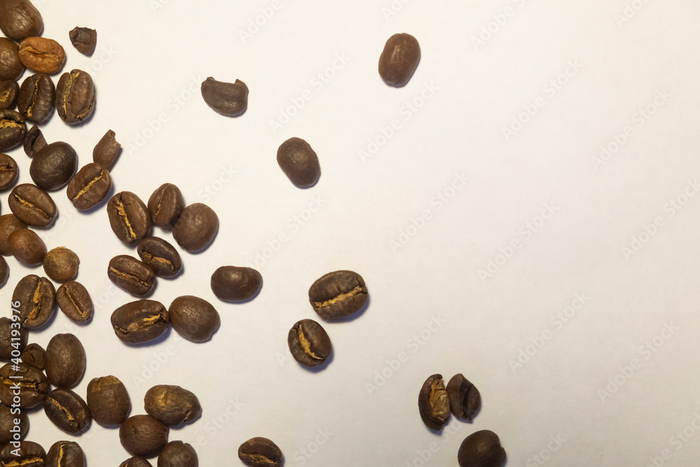 Obraz premium Coffee Beans isolated pile from top on white background area for copy space. Roasted brown coffee beans, can be used as a background and texture. 