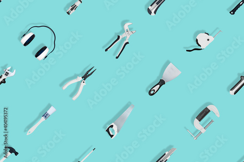 Tools seamless pattern. Various construction tools on an aquamarine background.