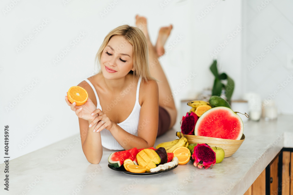 Woman smiling with a tropical fruits, dieting, healthy eating Woman smiling with a tropical fruits, dieting, healthy eating
