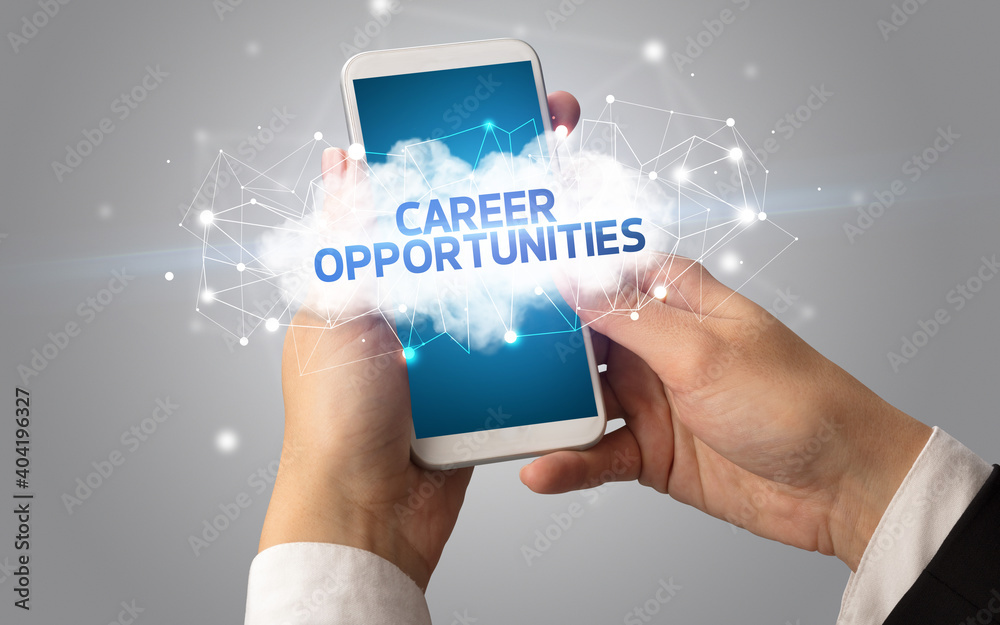 Female hand touching smartphone with CAREER OPPORTUNITIES inscription, cloud business concept Female hand touching smartphone with CAREER OPPORTUNITIES inscription, cloud business concept