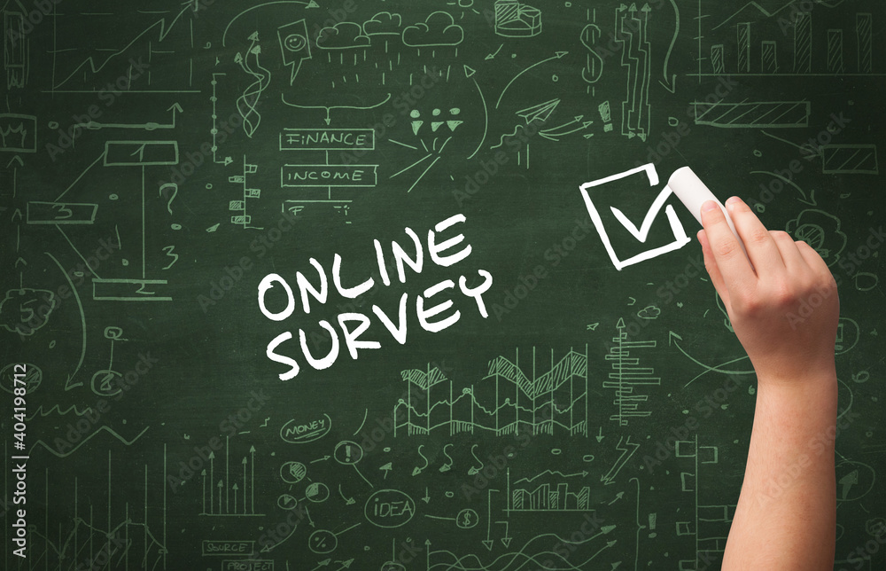 Hand drawing ONLINE SURVEY inscription with white chalk on blackboard, new business concept Hand drawing ONLINE SURVEY inscription with white chalk on blackboard, new business concept