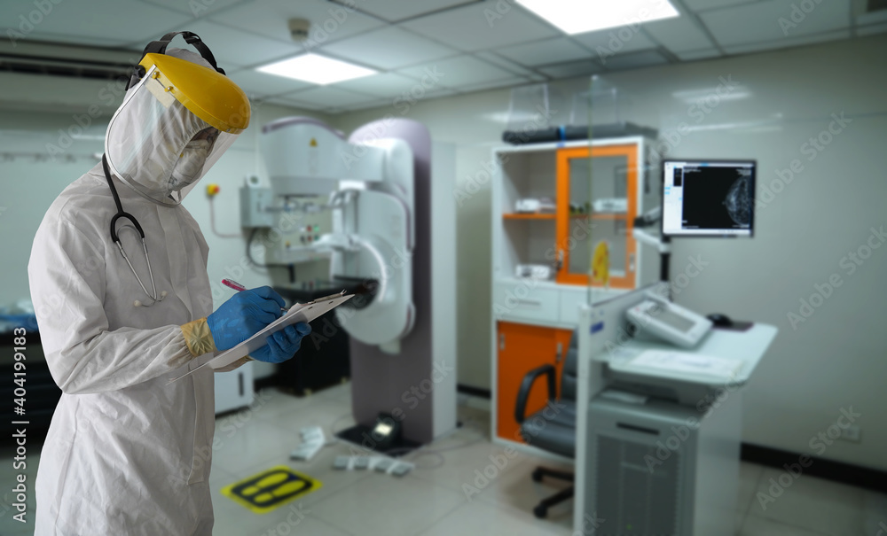 Naklejka premium Breast cancer Control room, Doctors in PPE protective clothing check breast cancer control room to protect patients infected with the COVID-19 coronavirus. 