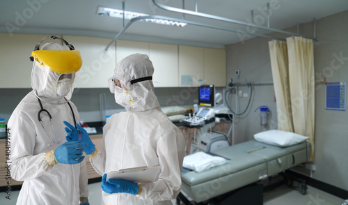 Orthopedic Control room, Doctors in PPE protective clothing inspect the orthopedic operating control room. To protect patients infected with the coronavirus COVID-19 