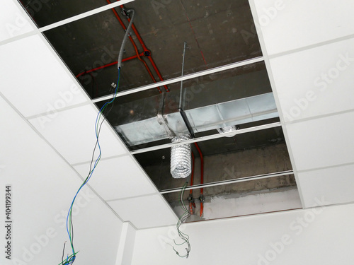 KUALA LUMPUR, MALAYSIA -JULY 24 2020: The suspended ceiling, electrical wiring, cabling and mechanical equipment under installation. It is hanging at the floor soffit. Cover by ceiling board. 