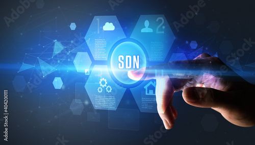 Hand touching SDN inscription, new technology concept