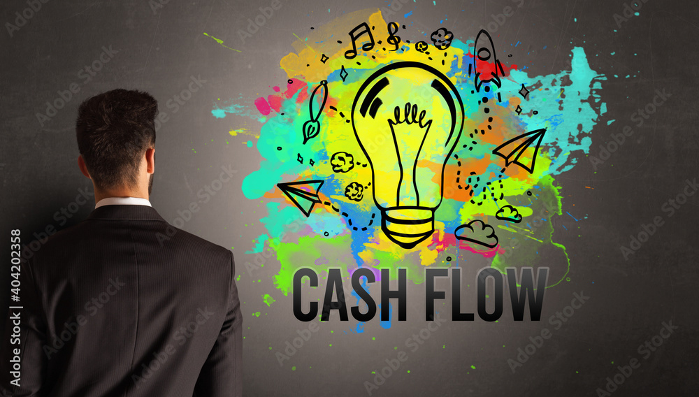 businessman drawing colorful light bulb with CASH FLOW inscription on textured concrete wall, new business idea concept businessman drawing colorful light bulb with CASH FLOW inscription on textured concrete wall, new business idea concept